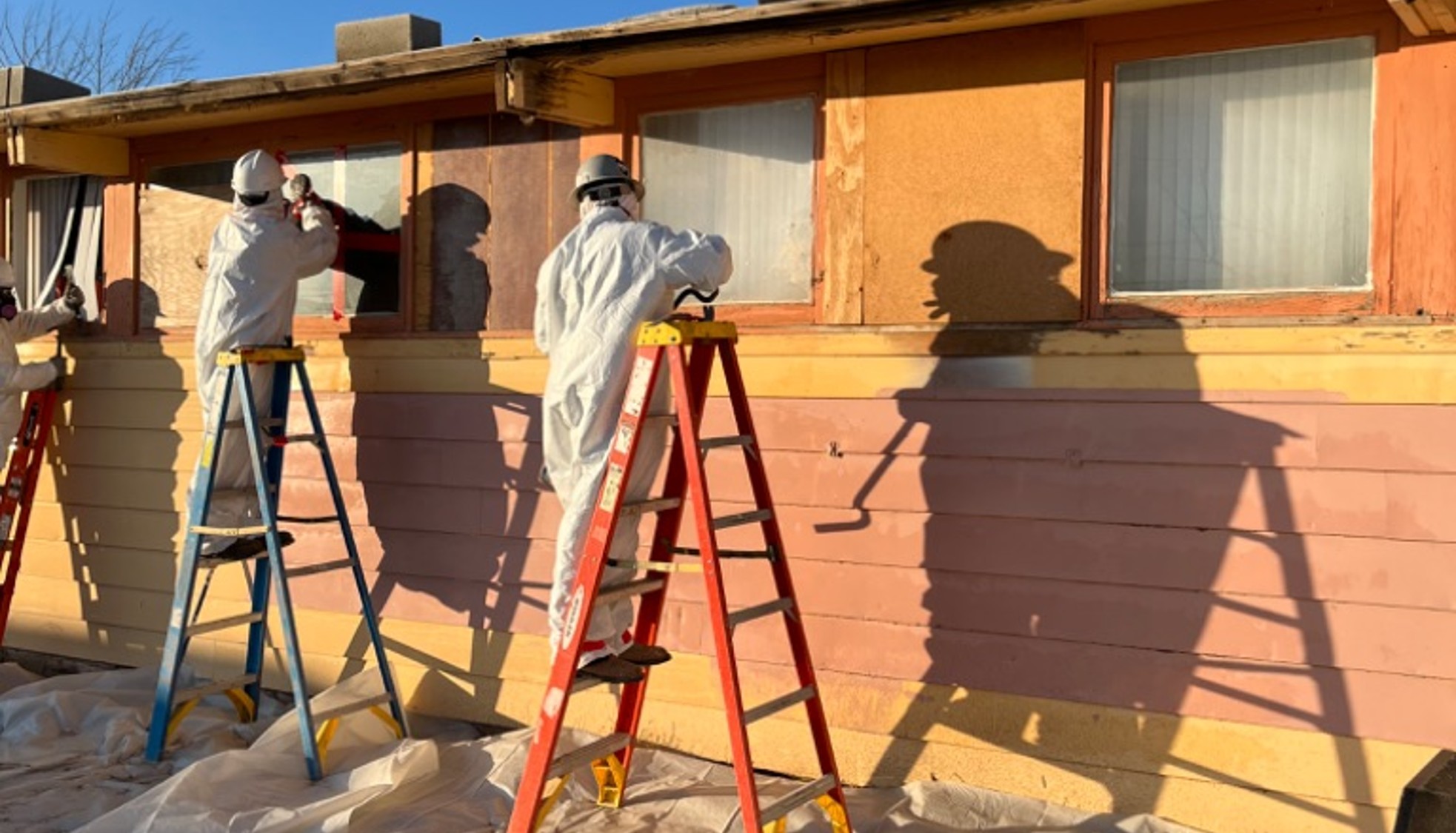 Workers remove the windows of a dormitory in the Navajo region