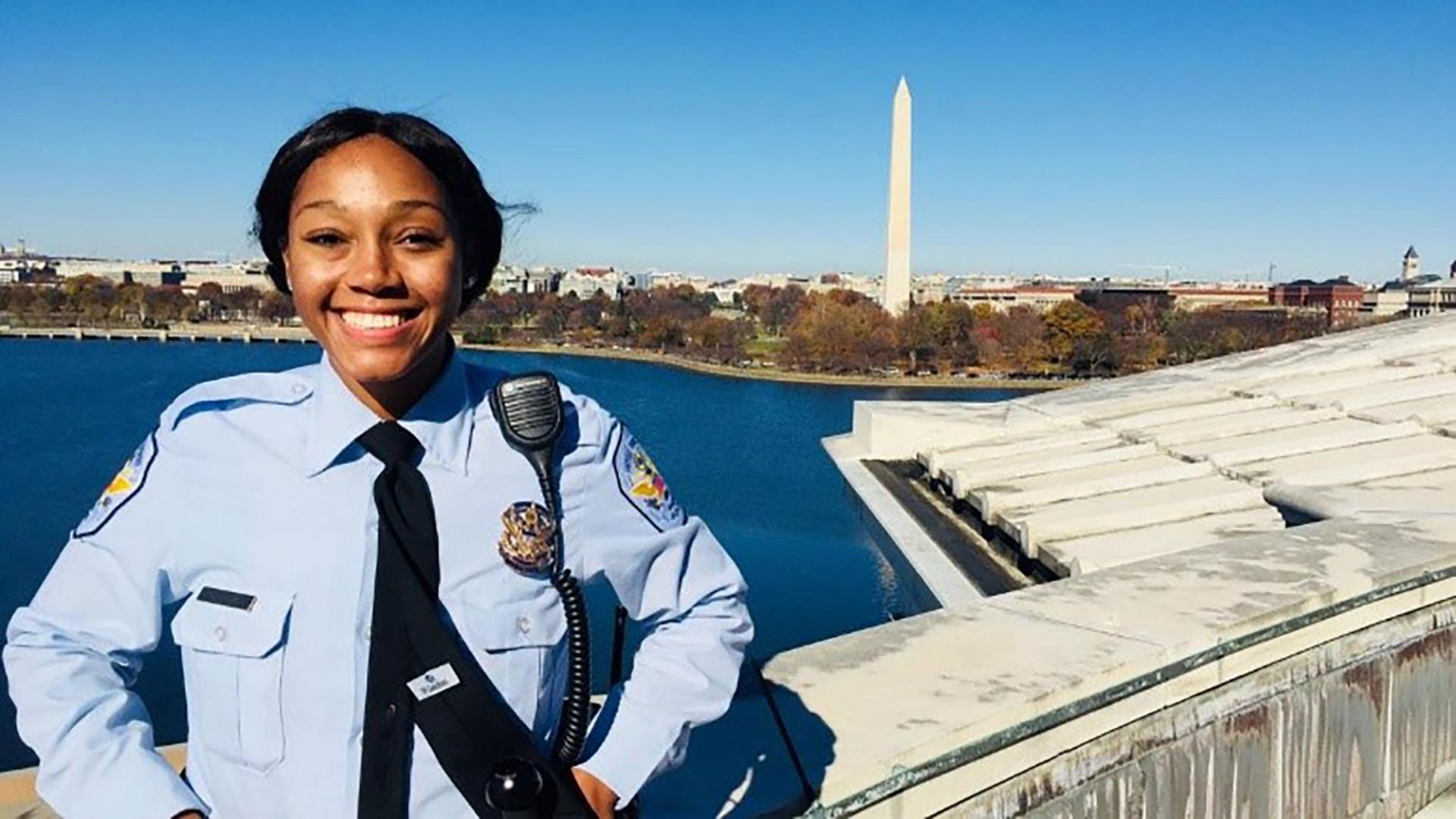 Woman in LE uniform poses in front of National Monument