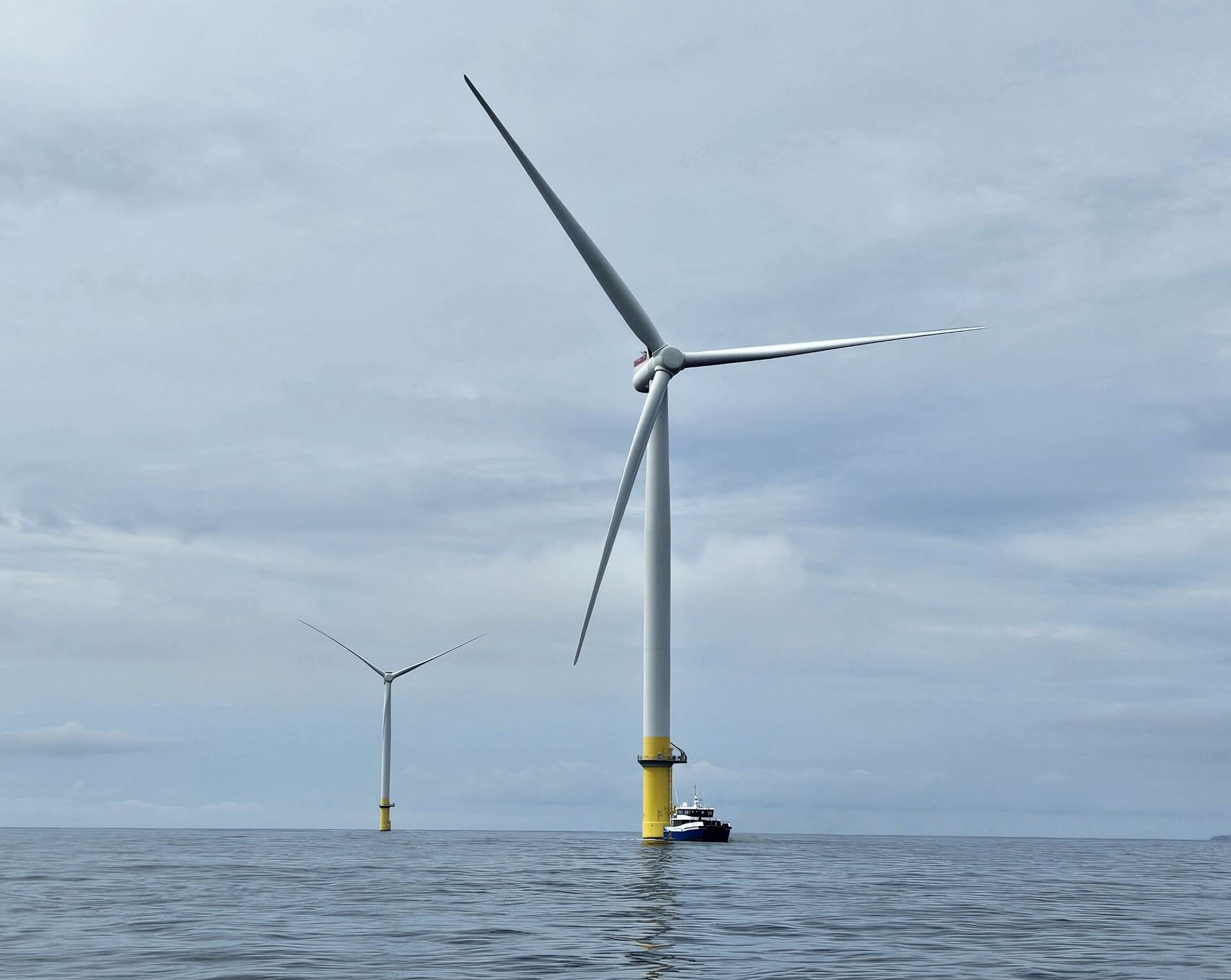 Two wind turbines in water.