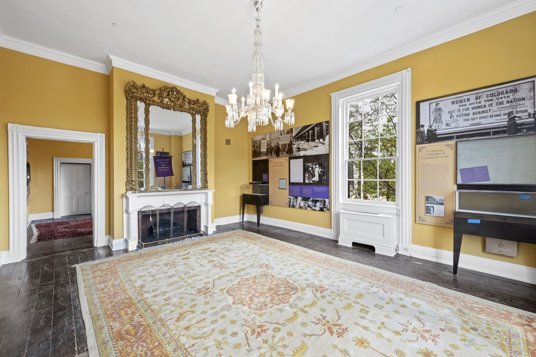 Yellow room in the historic Belmont Paul Hose with exhibits lining the walls.