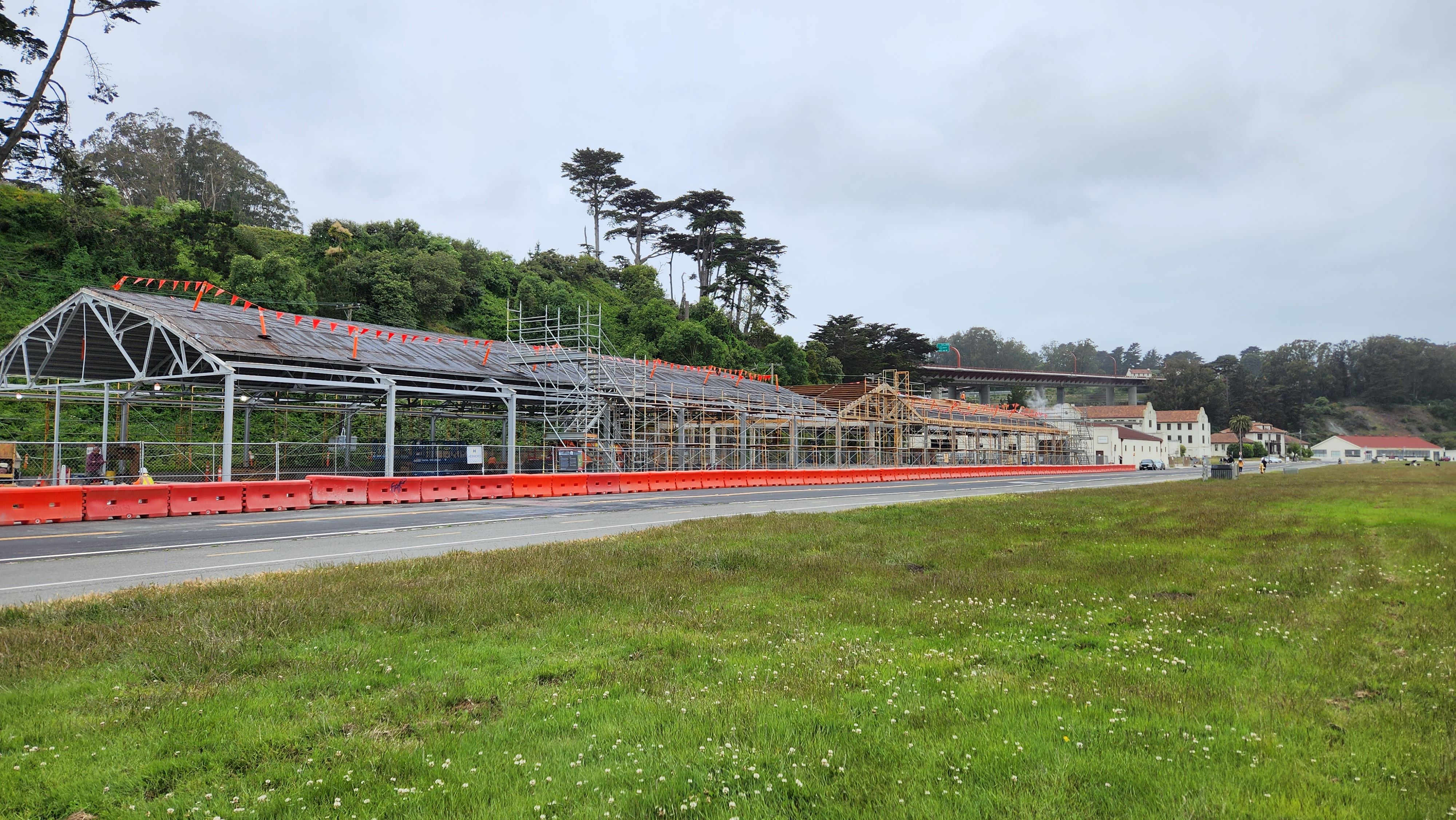 Scaffolding surrounds the metal framework of the Presidio Building.