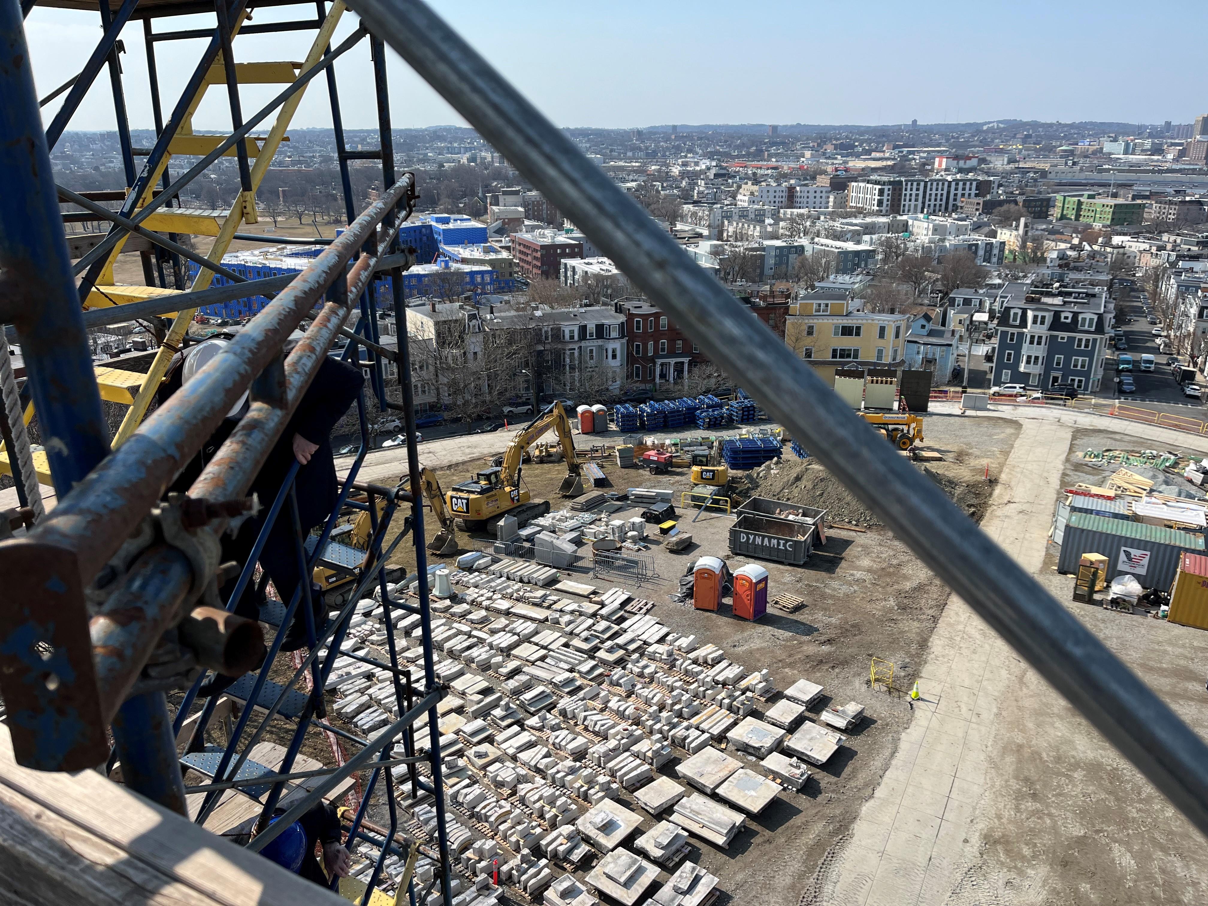 Aerial view of construction site surrounded by colorful buildings.