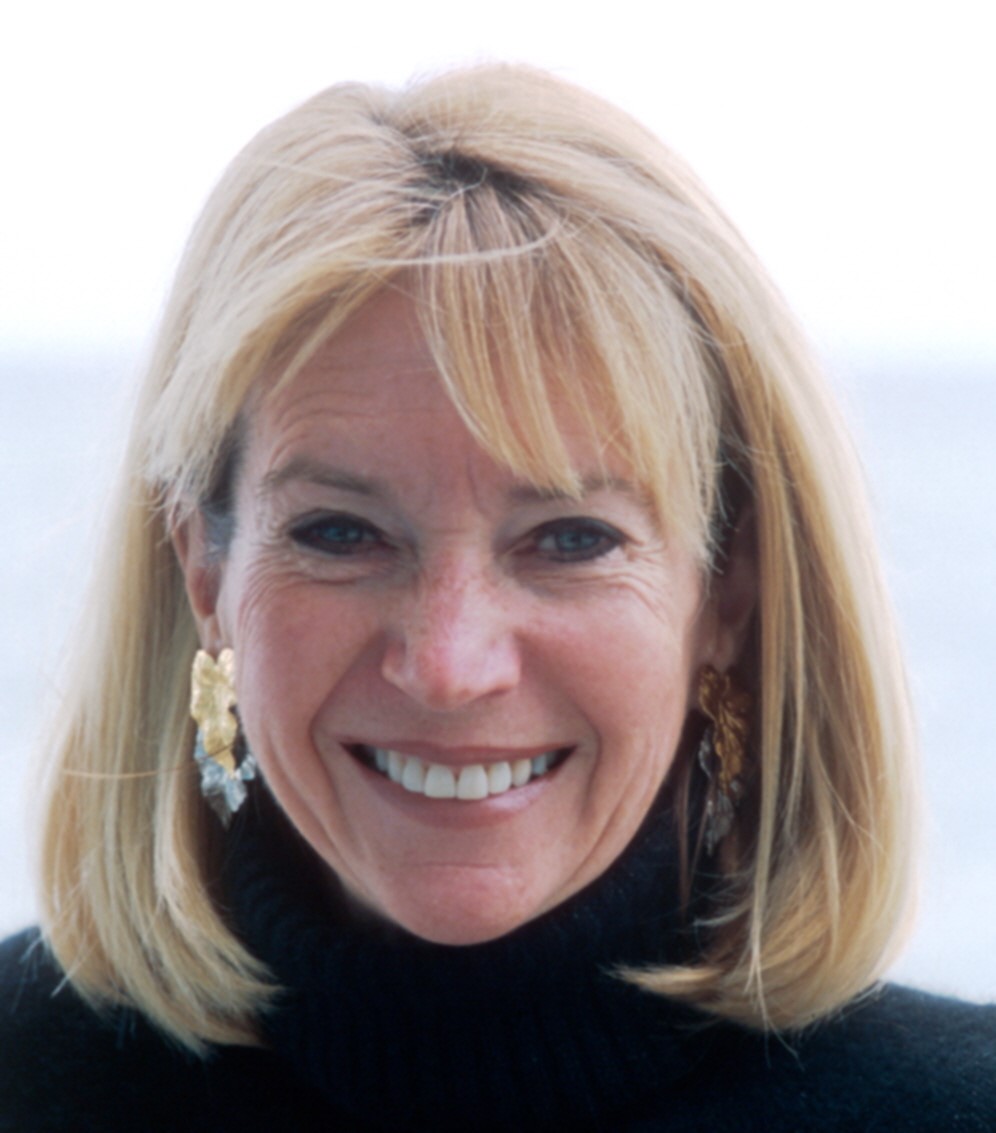  Marcia McNutt, a woman with short blonde hair wearing a black shirt, smiles into the camera. 