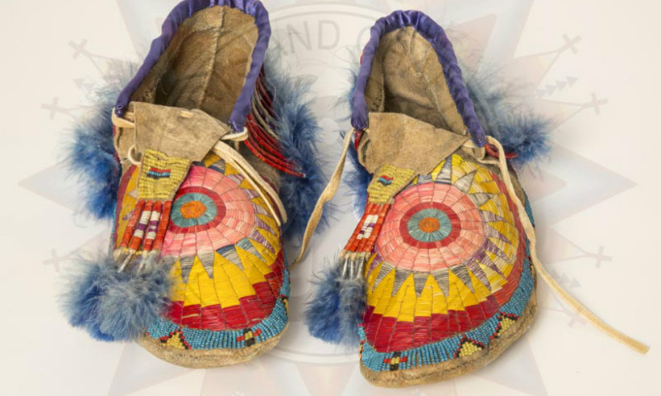Photograph of beaded moccasins with an IACB watermark.