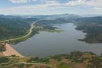 Aerial view of Jordanelle Dam and Reservoir with highway to Park City on the Left and highway to Kamas on the right.