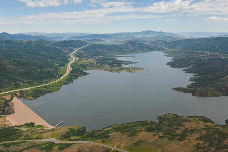 Aerial view of Jordanelle Dam and Reservoir with highway to Park City on the Left and highway to Kamas on the right.