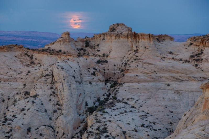 Full moon behind pink clouds at Grand Staircase-Escalante.