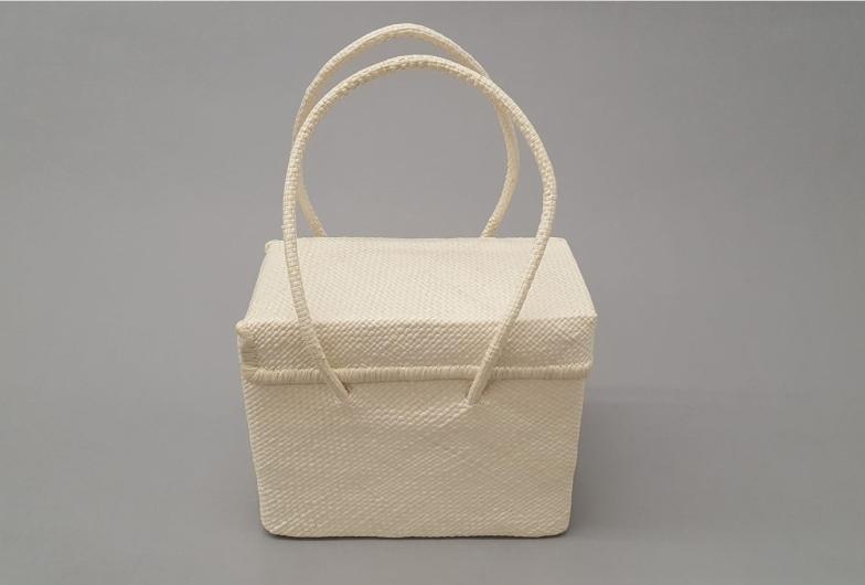 White woven bag with handles.