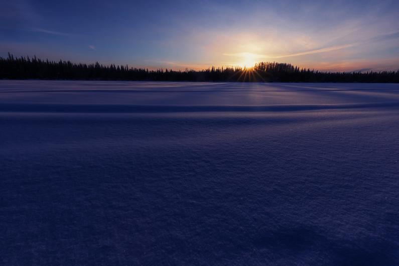 Sunrise over snowy lake at Kenai National Wildlife Refuge in Alaska.