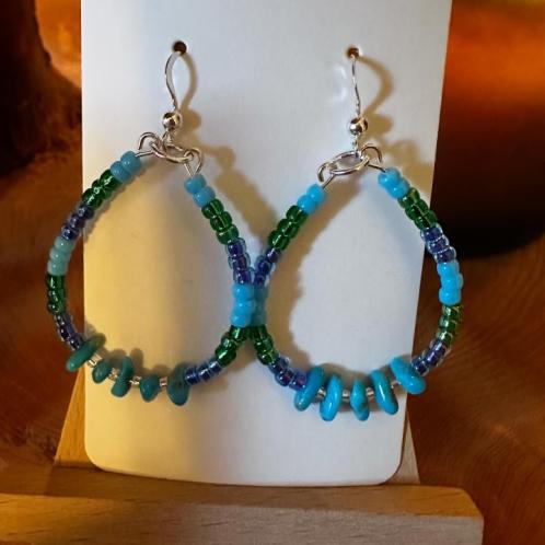 A pair of blue, green, and purple beaded earrings.
