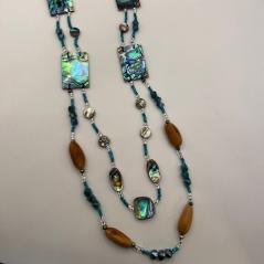 Photograph of a necklace made with brown, blue, and iridescent beads. 