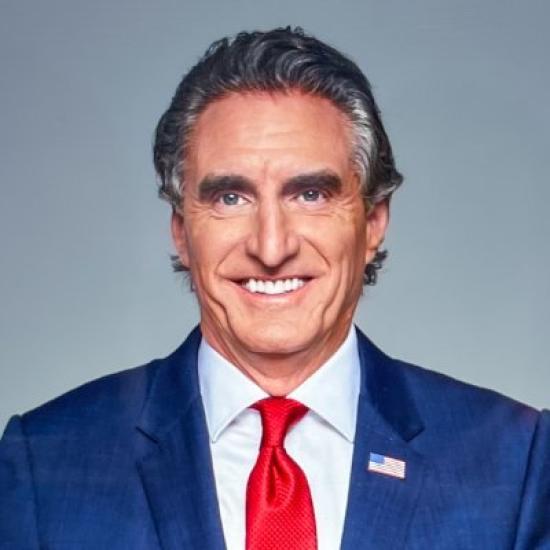 Secretary Doug Burgum Portrait wearing red tie and American Flag Pin