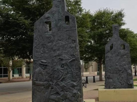 Statues that suggest the remnants of burned houses at the Springfield 1908 Race Riot Memorial in Springfield, Illinois. 