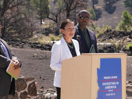 Secretary Haaland speaking behind podium