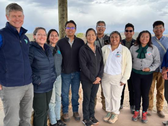 Secretary Haaland stands for a photo with stakeholders 