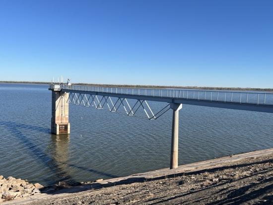 Bridge-like structure in body of water. 