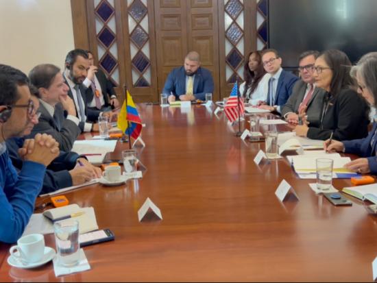 Secretary Haaland and Interior officials sit at a large conference table across from Colombian government officials