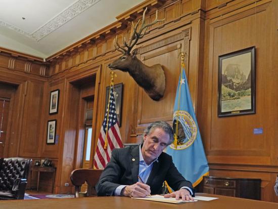 Secretary Burgum signs Secretary Order in his office.