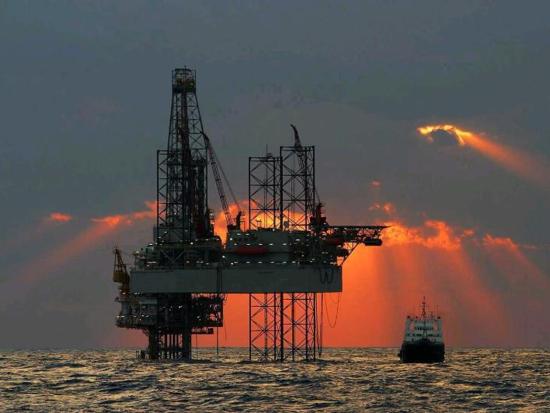 Offshore Oil rig with Orange sunset in background