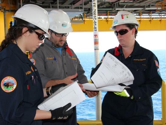 BSEE engineers examine documents on an offshore rig