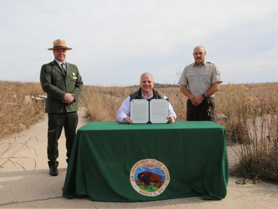 Secretary Bernhardt Signs an order at park