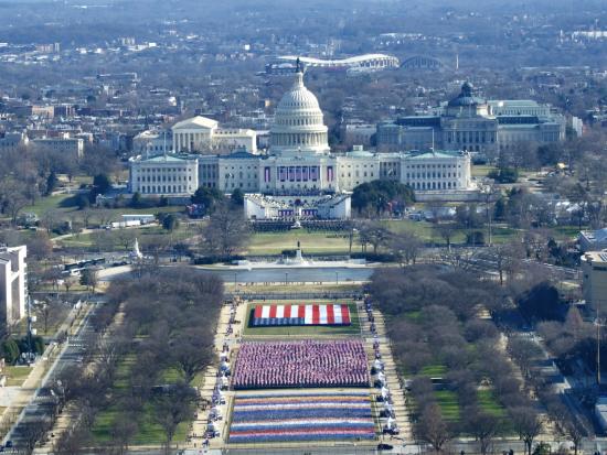 Photo of inauguration with flags and the Capitol