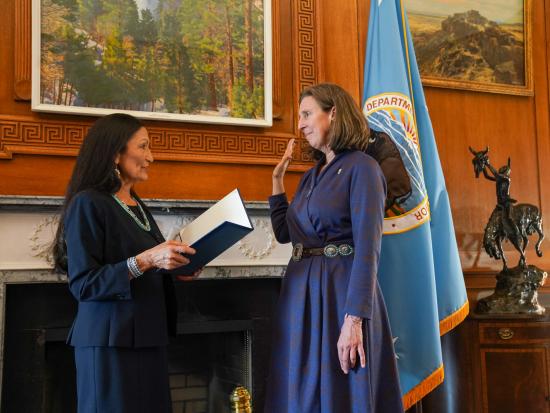 Martha Williams being sworn in by Secretary Haaland.