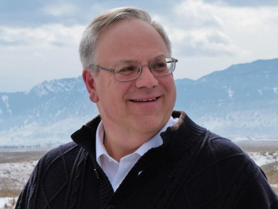 Secretary Bernhardt is a white mane with gray hair wearing glasses and standing outside.