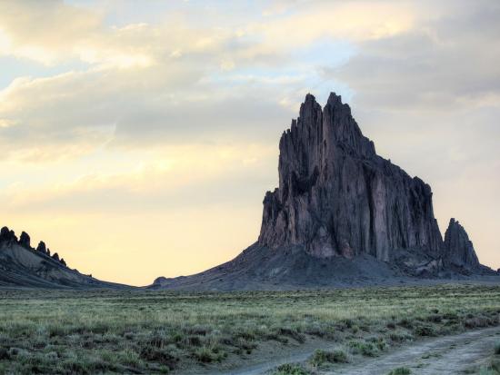Shiprock in the distance under a cloudy sky.