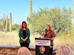 Laura Daniel Davis stands at a podium as she announces the funding. 