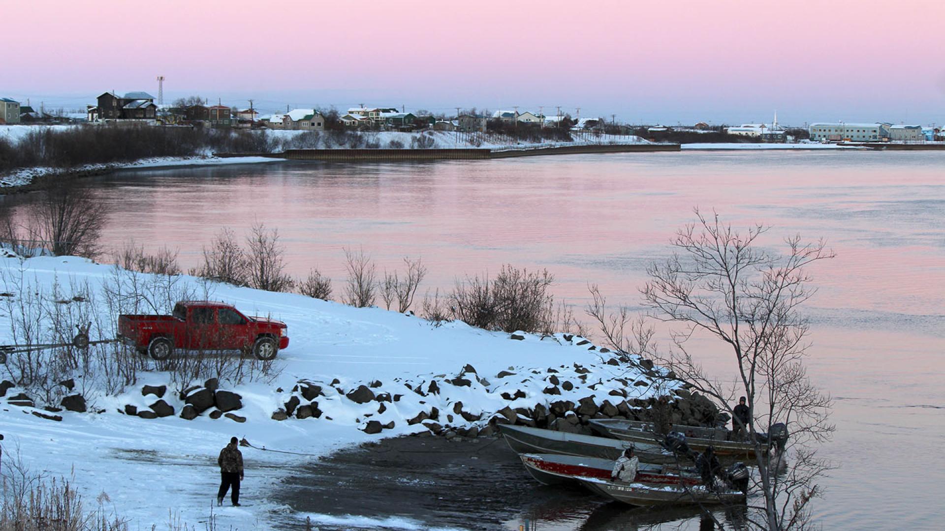 men getting boats ready on a snowy bank of Kuskokwim River