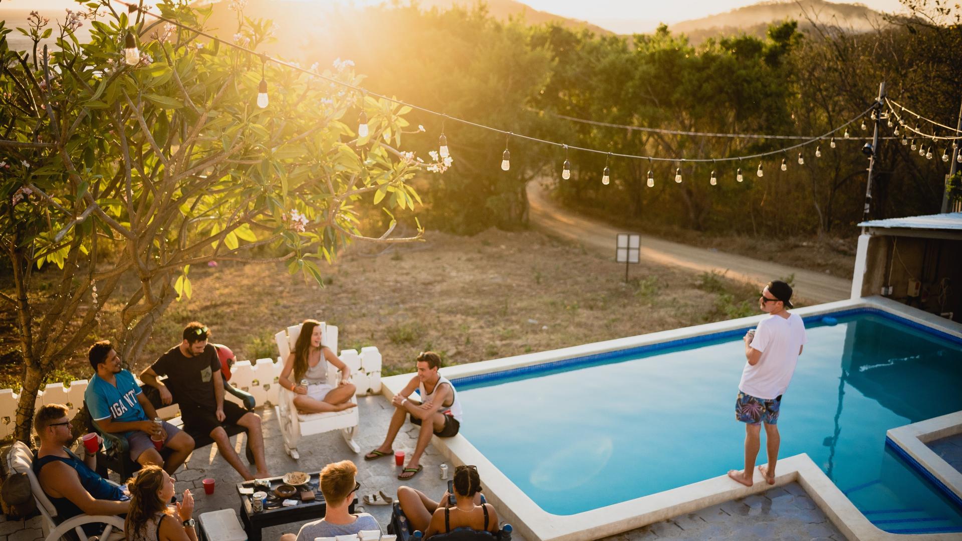 Picture of friends socializing next to a swimming pool