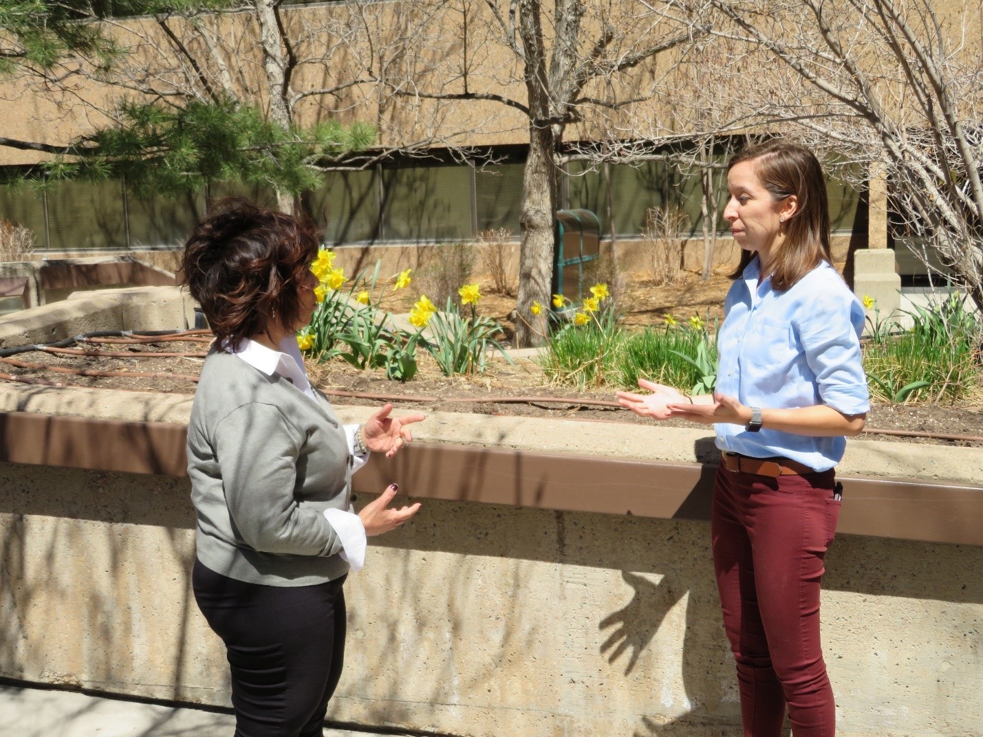 Brittany Gonzalez speaks to a colleague outside.