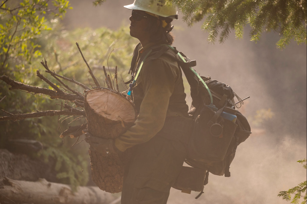 Firefighter clears debris at the Cougar Creek Fire.