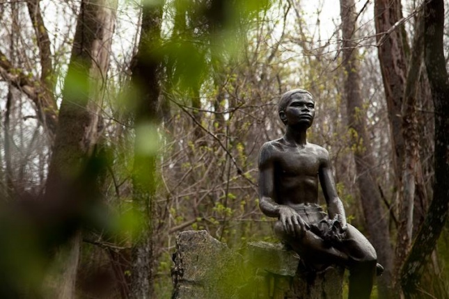 A statue of a young African American boy at the George Washington Carver Memorial.