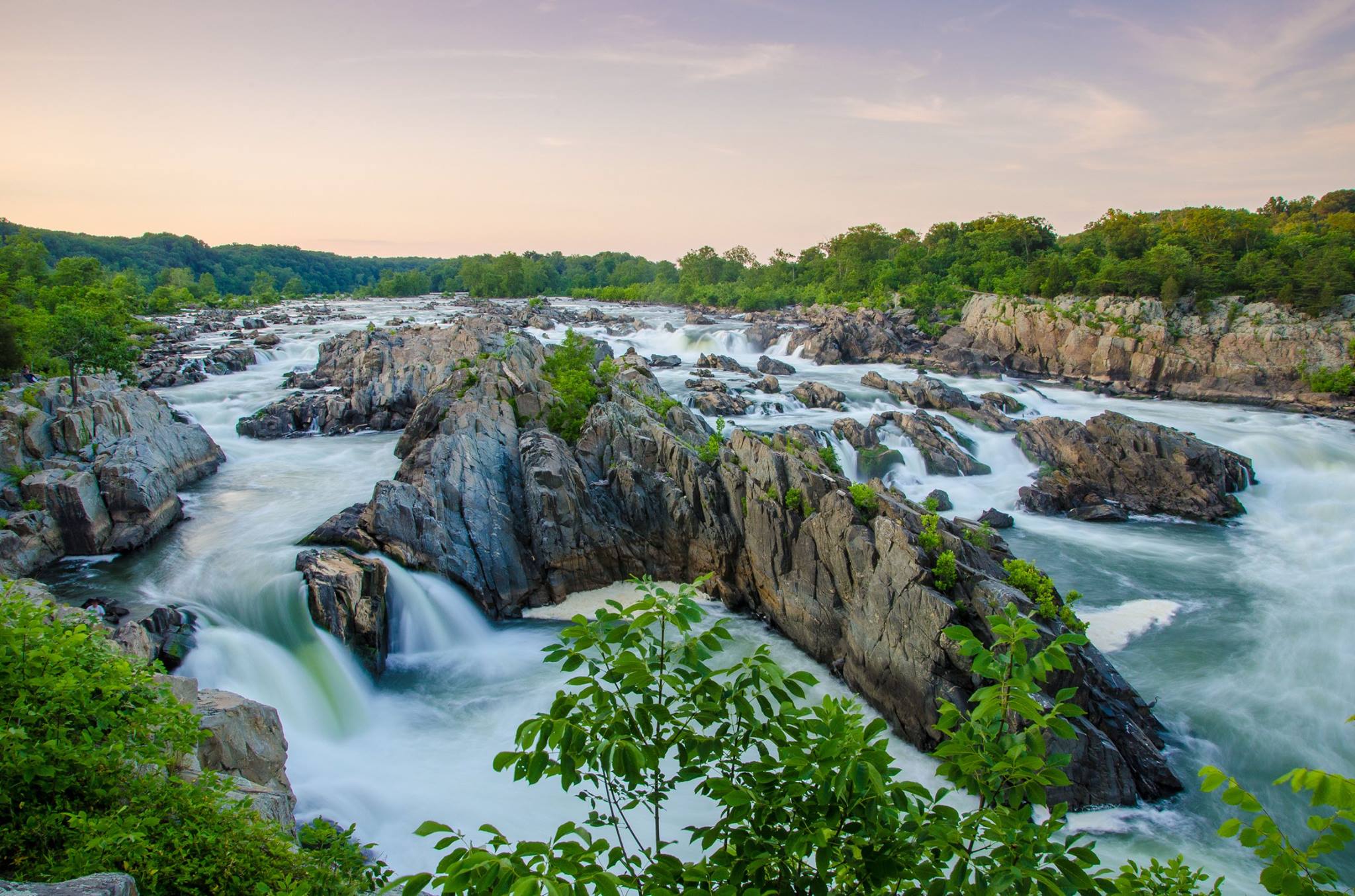 Rushing water spills over the waterfalls at Great Falls Park in Virginia.