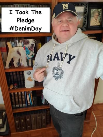 William Civish from BIA holding the I took the Pledge #DenimDay sign. 