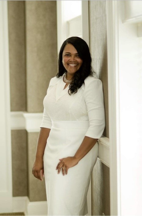 Portrait of Tershara Matthews, smiling and wearing a white dress.