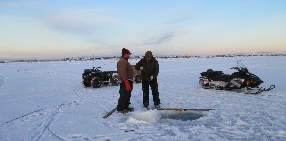 Members of the Iñupiaq community ice-fishing