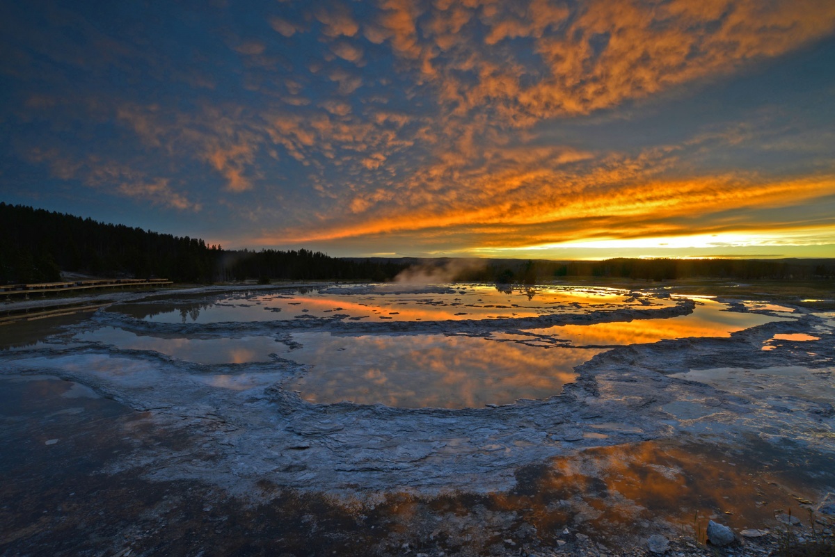 golden skies and steaming geyser