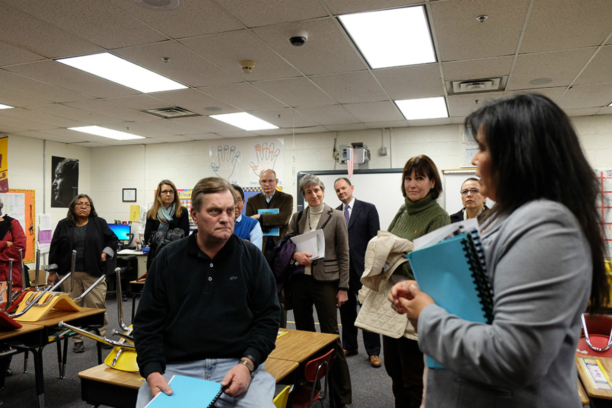 Secretary Jewell listening to a group of teachers in a classroom.
