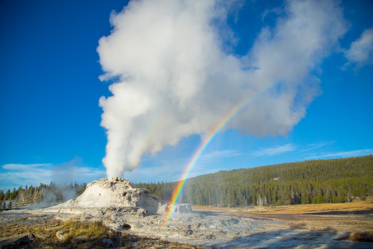 Geyser erupts, creating rainbow