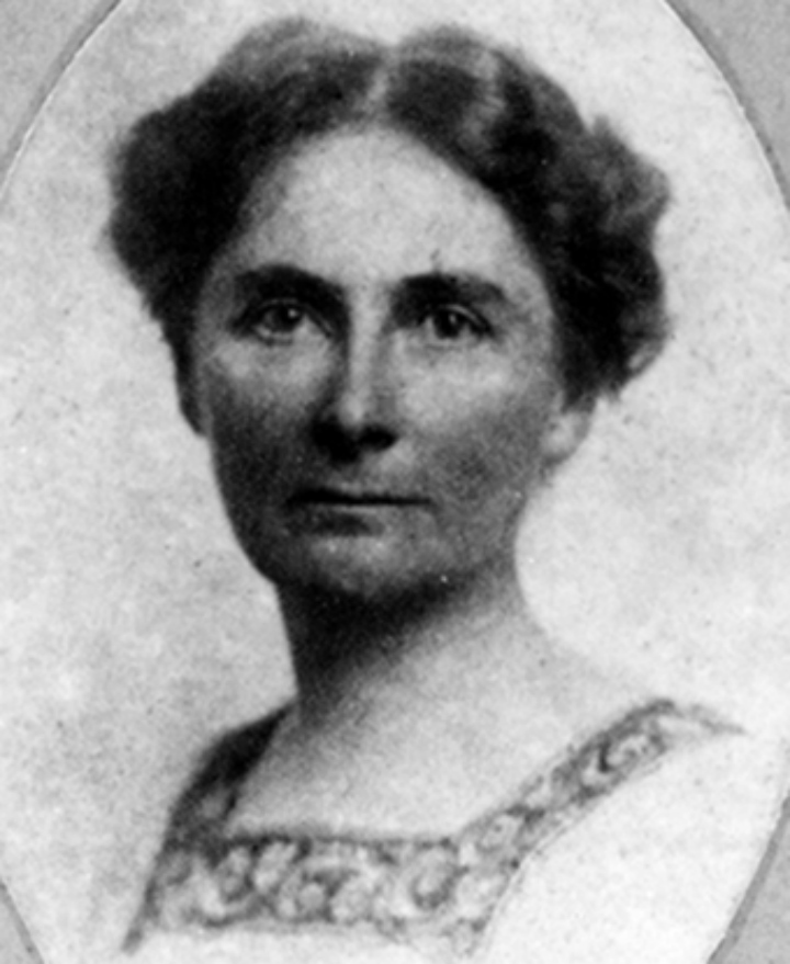 A historic photo of a woman with dark hair looking at the camera.