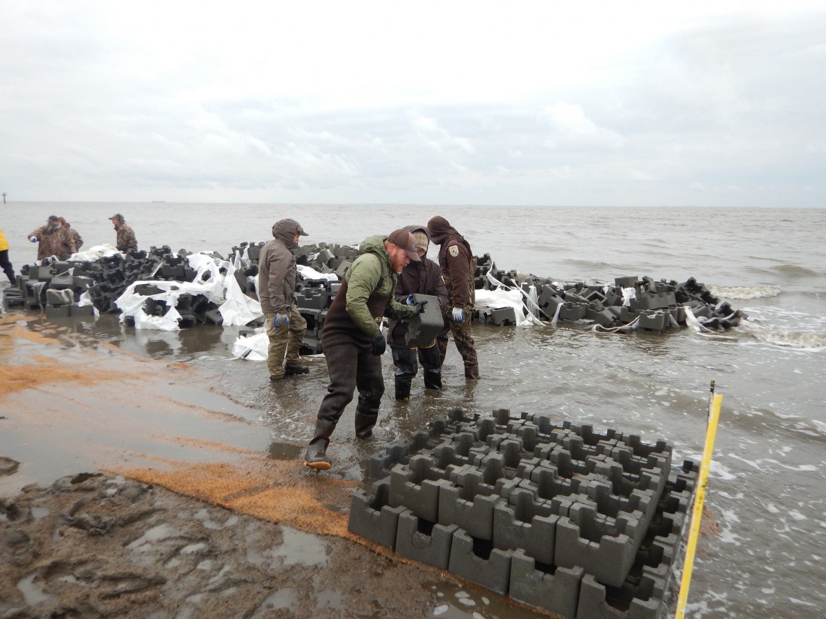Employees build oyster castles at Gandy’s Beach.