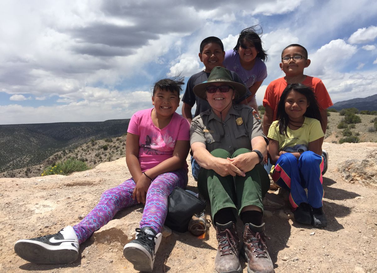 Children sit with a National Park Service ranger in New Mexico.