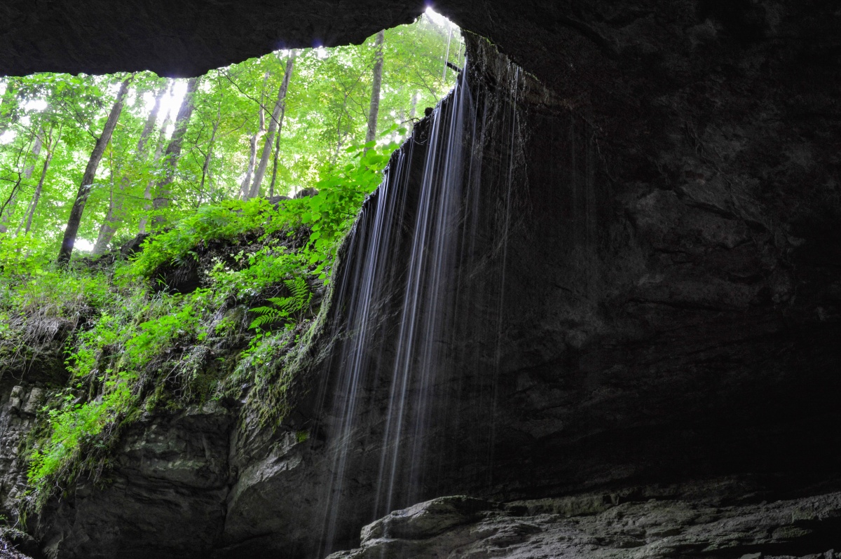 Water flows off the edge of a natural opening to Mammoth Cave.