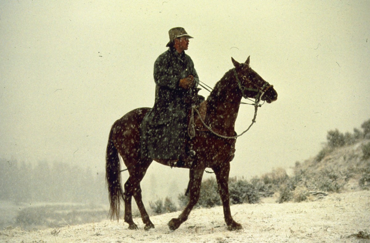 Mark Haroldson rides a horse in the snow.
