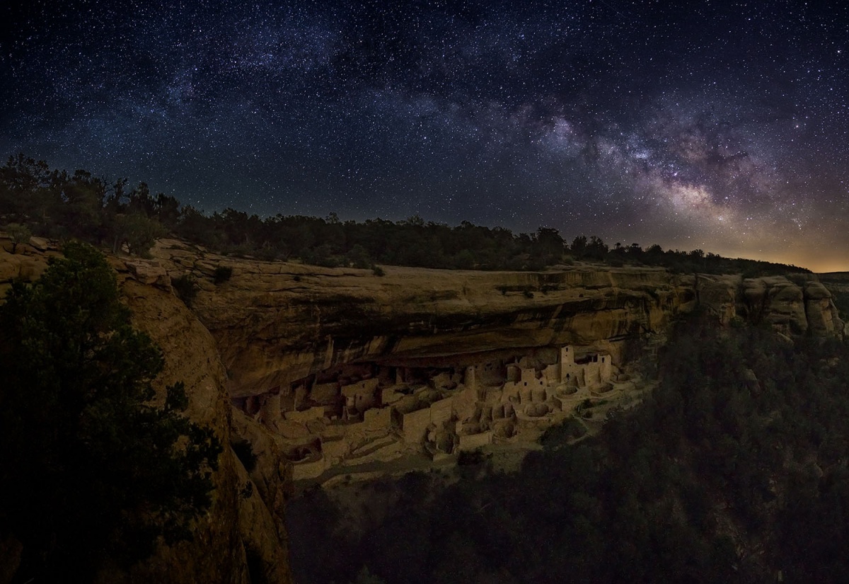 stars over ancient building in the cliffs