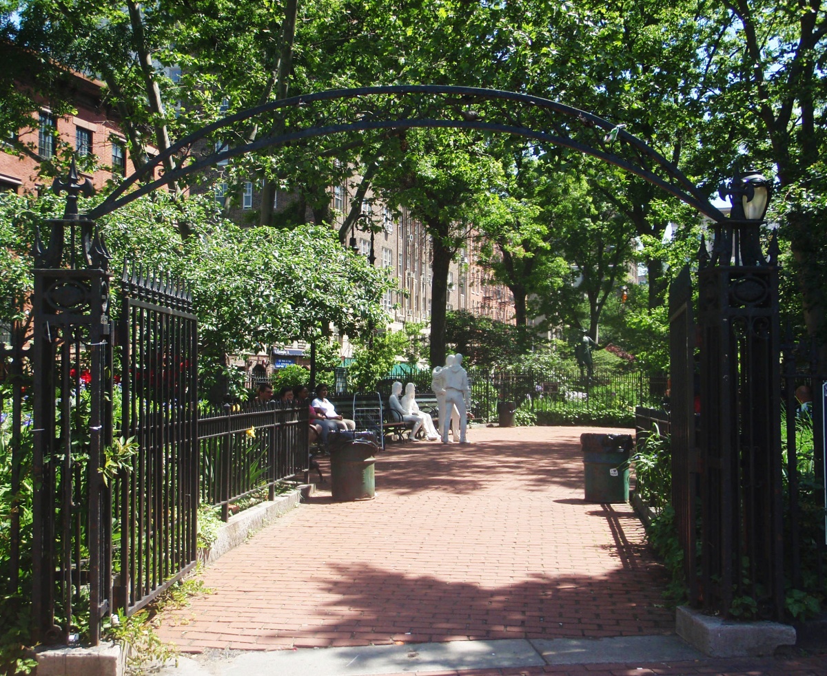 sidewalk through a tree-filled park