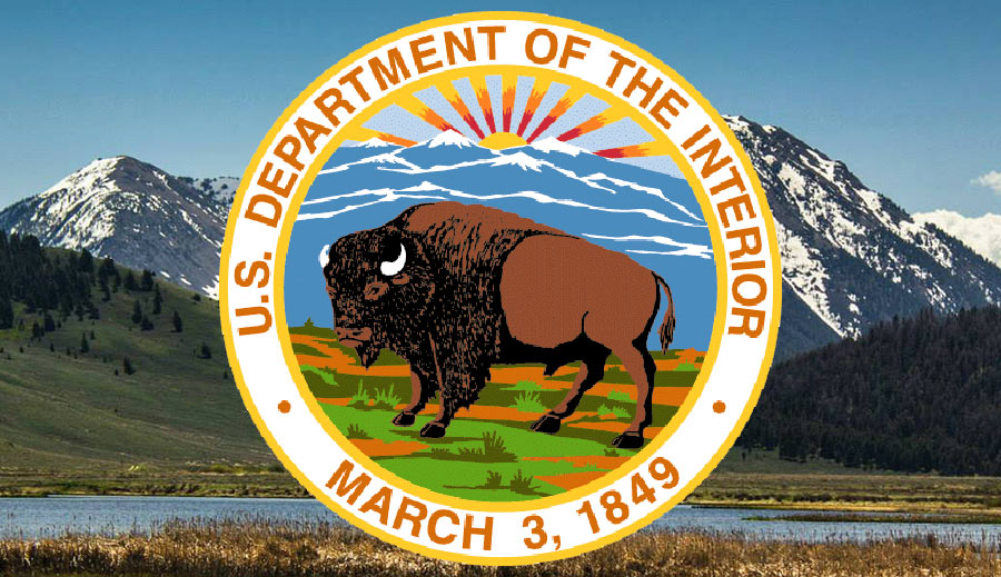 Department of the Interior bison seal set against green mountainous background.
